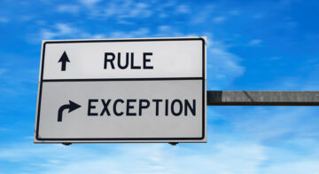 A street sign with an arrow pointing straight ahead to "Rule" and an arrow to thje right for "Exception."